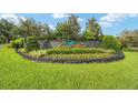 A stone monument announces the Laurel Wood community, surrounded by a lush green lawn at 2908 Se 22Nd Ave, Ocala, FL 34471