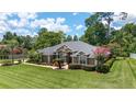 Well maintained single-story home featuring beautiful landscaping, verdant lawn and manicured shrubbery at 2908 Se 22Nd Ave, Ocala, FL 34471