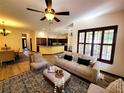 Open-concept living room featuring hardwood floors, a stylish ceiling fan, and abundant natural light at 3803 Se 6Th Ave, Ocala, FL 34480