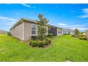 Well-maintained backyard with lush green grass, shrubs, and a privacy fence at 4474 Nw 53Rd Ave Rd, Ocala, FL 34480