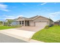 Charming single-story home featuring a well-manicured lawn and a two-car garage at 4474 Nw 53Rd Ave Rd, Ocala, FL 34480