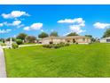 Inviting front yard featuring a well-maintained lawn and mature landscaping, offering great curb appeal at 6172 Sw 101St Pl, Ocala, FL 34476