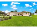 Beautifully maintained front yard with lush green grass and manicured landscaping surrounding a lovely home at 6172 Sw 101St Pl, Ocala, FL 34476