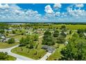 Sprawling community showcasing well-kept lawns, mature trees, and blue skies at 6773 Se 87Th St, Ocala, FL 34472