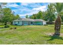 Single story home with lush green lawn, stone accents, and a two car garage at 6773 Se 87Th St, Ocala, FL 34472