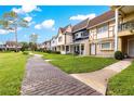 Picturesque street view showcasing charming townhouses and lush green landscaping at 8830 Sw 98Th Pl # M, Ocala, FL 34481