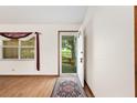Bright entryway featuring wood-look floors, a window, and natural light at 8959 Sw 96Th Ln # A, Ocala, FL 34481