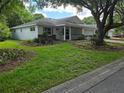 Charming single Gathering home with a two-car garage, front porch, and a well-maintained front lawn at 8959 Sw 96Th Ln # A, Ocala, FL 34481