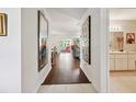 Bright entryway with hardwood floors offering views into the living room and bathroom at 8961 Sw 96Th Ln # C, Ocala, FL 34481