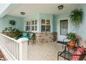 Inviting front porch with tiled flooring and decorative plants creating a welcoming entrance at 8961 Sw 96Th Ln # C, Ocala, FL 34481