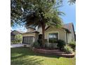 Well-maintained single-Gathering home featuring mature trees, a two-car garage, and tasteful landscaping at 9395 Sw 70Th Loop, Ocala, FL 34481