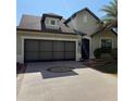 Charming home with a two-car garage and a decorative compass on the driveway at 9395 Sw 70Th Loop, Ocala, FL 34481