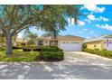 Charming single-story home featuring a two-car garage, well-maintained landscaping, and a light beige stucco exterior at 9746 Sw 89Th Loop, Ocala, FL 34481
