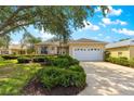 Charming single-story home featuring a two-car garage, well-maintained landscaping, and a light beige stucco exterior at 9746 Sw 89Th Loop, Ocala, FL 34481