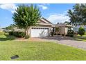 Attractive single-story home featuring a brick driveway, lush lawn, and well-maintained landscaping at 9926 Sw 95Th Loop, Ocala, FL 34481