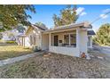 Attractive home with a quaint front porch featuring chairs and a traditional door at 114 Ne 11Th Ave, Ocala, FL 34470