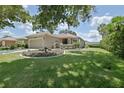 Well-maintained home with a lush lawn, mature trees, and a lovely landscaped garden in the front yard at 13170 Se 92Nd Court Rd, Summerfield, FL 34491