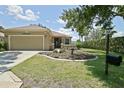 Inviting single-Gathering home with landscaped front yard, mature tree, and an attached two-car garage at 13170 Se 92Nd Court Rd, Summerfield, FL 34491