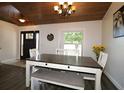 Bright dining area featuring a wooden table, white chairs, and decorative lighting at 1829 Nw 85Th Loop, Ocala, FL 34475
