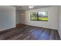 Inviting living room featuring modern wood-look floors, a large window, and ample natural light at 205 Ne 53Rd St, Ocala, FL 34479