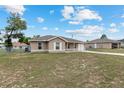 Single-story home with a fenced yard and well-maintained lawn under a sunny blue sky at 2690 Sw 154Th Ln, Ocala, FL 34473