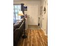 Inviting entryway featuring hardwood floors, a new door, and charming decor at 37 Oak Loop, Ocala, FL 34472
