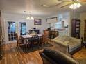 Open-concept living space with wood floors, a dining area, and a view of the kitchen at 37 Oak Loop, Ocala, FL 34472