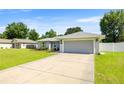 Single-story home with lush front lawn and a spacious two-car garage at 4325 Se 60Th St, Ocala, FL 34480