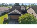 An aerial view showcases the home's roof, landscaping, and surrounding greenery at 4970 Nw 35Th Lane Rd, Ocala, FL 34482