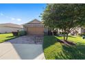 Charming single-story home with a brick-paved driveway and well-maintained lawn at 4970 Nw 35Th Lane Rd, Ocala, FL 34482