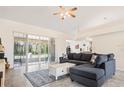 Spacious living room featuring tile floors, a comfortable sofa, and sliding glass doors to the patio at 4973 Sw 107Th Loop, Ocala, FL 34476