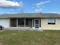 A charming one-story home featuring a screened porch, a single window, and an attached garage at 499 Water Rd, Ocala, FL 34472