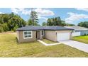 Charming single-story home with a well-maintained lawn and attached two car garage at 5 Dogwood Loop Ave, Ocala, FL 34472