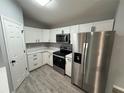 Well-lit kitchen with white cabinets, stainless steel appliances, and tile flooring at 5 Laurel Pass Ln, Ocala, FL 34472