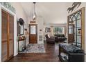 Inviting foyer with dark wood floors, decorative mirror, and view into the living room at 501 Marion Oaks Dr, Ocala, FL 34473