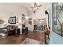 Spacious living room featuring vaulted ceiling, hardwood floors, and dining area in the background at 501 Marion Oaks Dr, Ocala, FL 34473