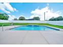 Sparkling pool with a waterfall feature in a beautifully maintained backyard oasis at 5459 Sw 86Th St, Ocala, FL 34476