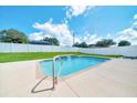 Inviting pool with a waterfall feature and a serene setting, perfect for relaxation and enjoyment at 5459 Sw 86Th St, Ocala, FL 34476