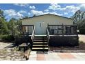 Home featuring a back entry with wooden deck and steps at 5862 Sw 160Th Ct, Ocala, FL 34481
