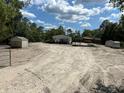 Property featuring sandy lot with outbuildings and carports at 5862 Sw 160Th Ct, Ocala, FL 34481