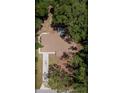 Aerial view of home showing roof, driveway, and surrounding lush greenery at 6475 Nw 61St Ave, Ocala, FL 34482