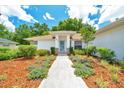 Inviting front entrance with manicured landscaping and walkway leading to the front door at 6631 Se 11Th Loop, Ocala, FL 34472