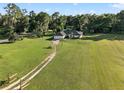 Expansive property featuring a single-story home and a lush green yard with mature trees at 6730 Sw 9Th Ave, Ocala, FL 34476