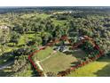 Aerial view showcasing a home with a large lot surrounded by trees, property line highlighted at 6730 Sw 9Th Ave, Ocala, FL 34476
