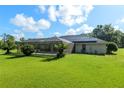 Expansive backyard with lush green lawn, screened-in patio, and solar panels at 6730 Sw 9Th Ave, Ocala, FL 34476