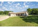 Well-maintained home with lush green lawn and mature landscaping at 7443 Sw 102Nd Pl, Ocala, FL 34476