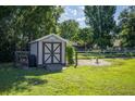 Backyard shed on a lush lawn, perfect for extra storage at 7443 Sw 102Nd Pl, Ocala, FL 34476