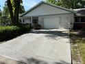 Charming single-story home featuring a light brick facade, attached garage, and well-maintained landscaping at 8874 Sw 95Th St # B, Ocala, FL 34481