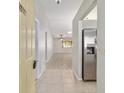 Bright foyer with tile flooring, stainless steel refrigerator, and an open view to the living area at 9460 Sw 84Th Ter # F, Ocala, FL 34481