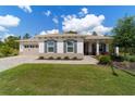 Inviting one-story home boasting manicured landscaping, beautiful stone accents, and a two-car garage at 9746 Sw 108Th Terrace Rd, Ocala, FL 34481